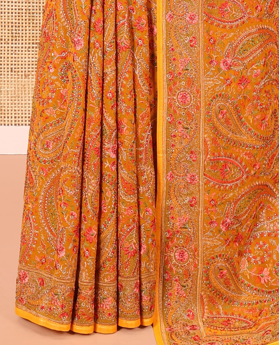 Mustard Georgette Saree, Ornamented with Intricate Paisleys, Kashmir Embroidered and Stone Work on Its Body, a Self-Embroidered Border, and Paired with an Embroidered Blouse