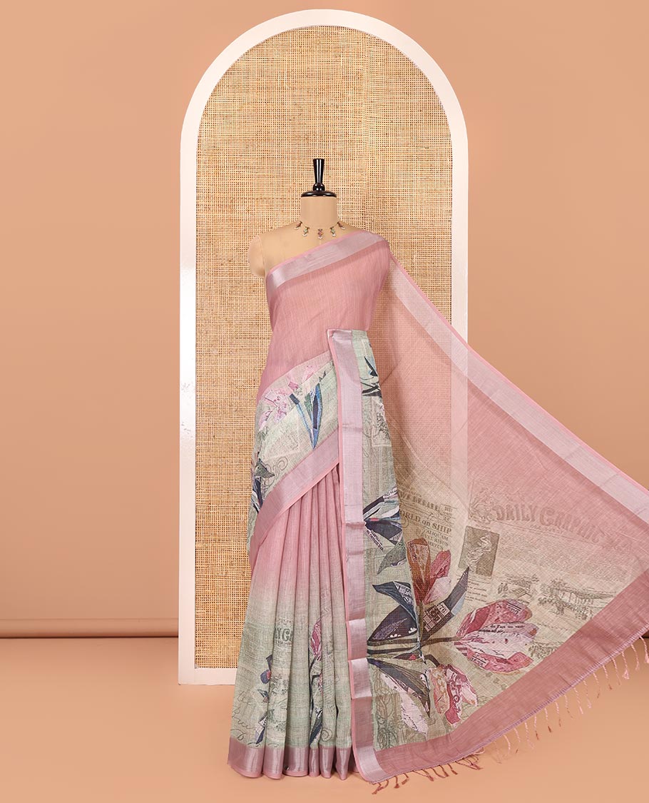 Green and Dusky Pink Linen Cotton Saree, Creatively Designed with Tropical Floral, and Newspaper-Texture Printed on Its Body, Complemented by a Silver Tissue Border, a Self-Printed Pallu, and Paired with a Matching Blouse