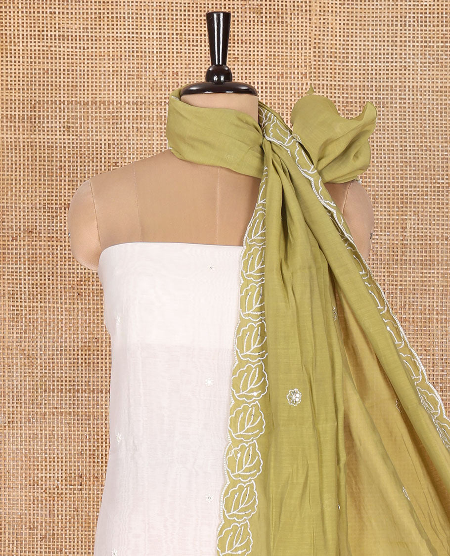Cream and Green Mul Chanderi Material Chudidar Set, Meticulously Crafted with Floral Embroidery On Its Top, A Plain Santoon Bottom, and Comes with a Contrast Scallop Floral Embroidered Dupatta
