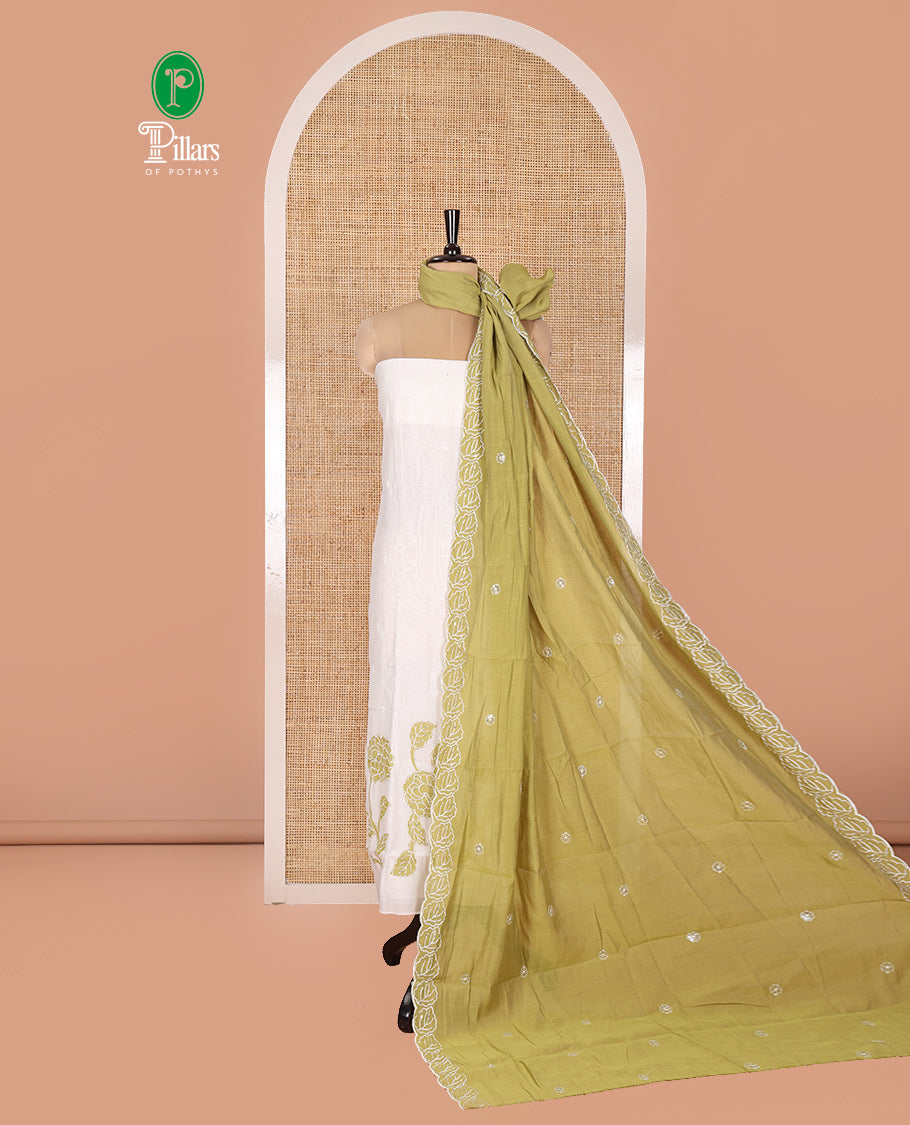 Cream and Green Mul Chanderi Material Chudidar Set, Meticulously Crafted with Floral Embroidery On Its Top, A Plain Santoon Bottom, and Comes with a Contrast Scallop Floral Embroidered Dupatta