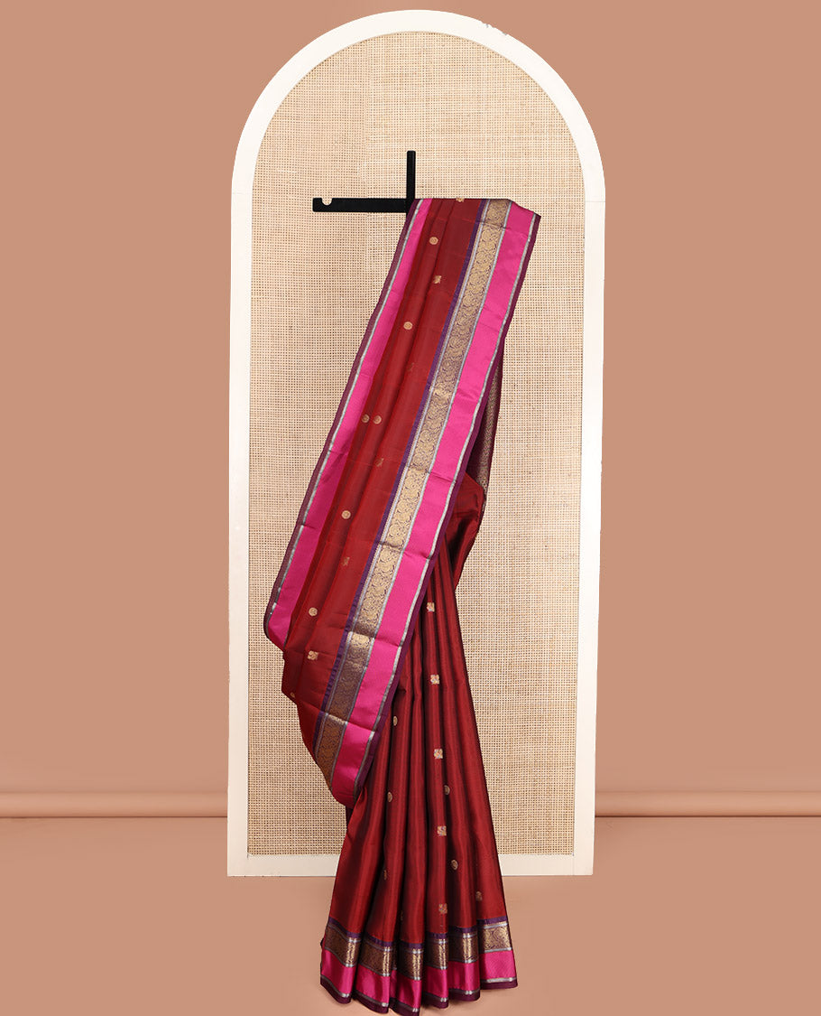 Maroon Vasundhara Lite Silk Mix Saree, Accentuated with Annam Chakram Zari Buttas, Complemented by a Contrast Rettai Pettu Border of Rekku, Kathir, and Mayil Designs, Meticulously Designed Pallu, and Paired with a Contrast Blouse