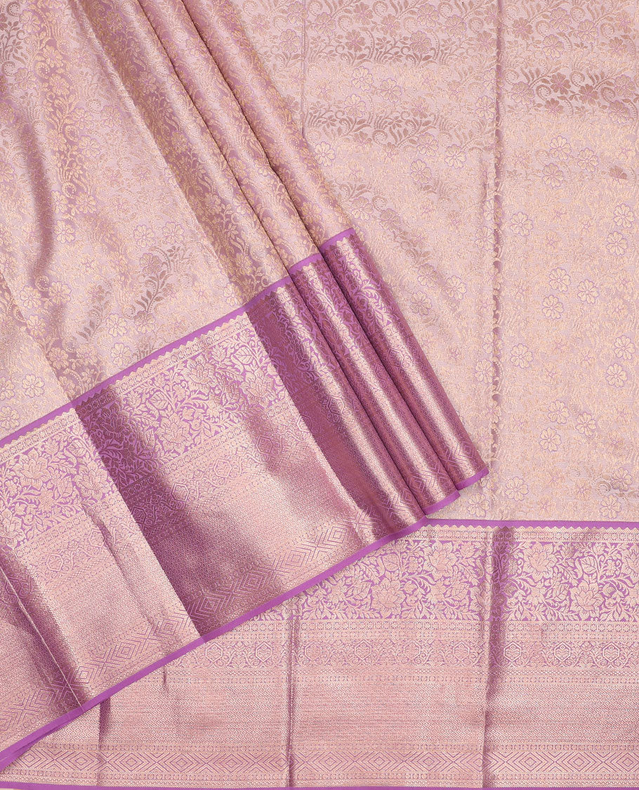 Pink pure-silk half-saree, jacquard skirt, contrast blouse, and border of rekku, poun, floral, kuyil kann, diamond, and then kuli kann designs, and intricate dhavani