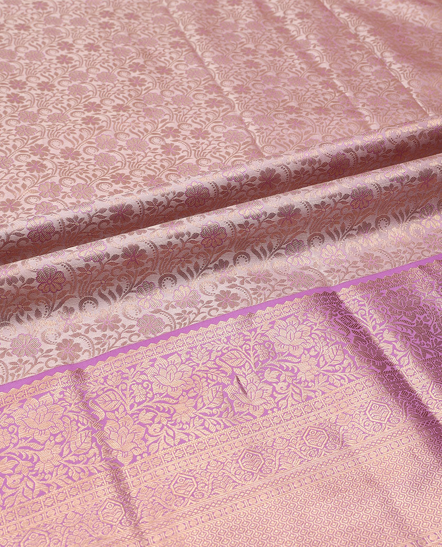 Pink pure-silk half-saree, jacquard skirt, contrast blouse, and border of rekku, poun, floral, kuyil kann, diamond, and then kuli kann designs, and intricate dhavani