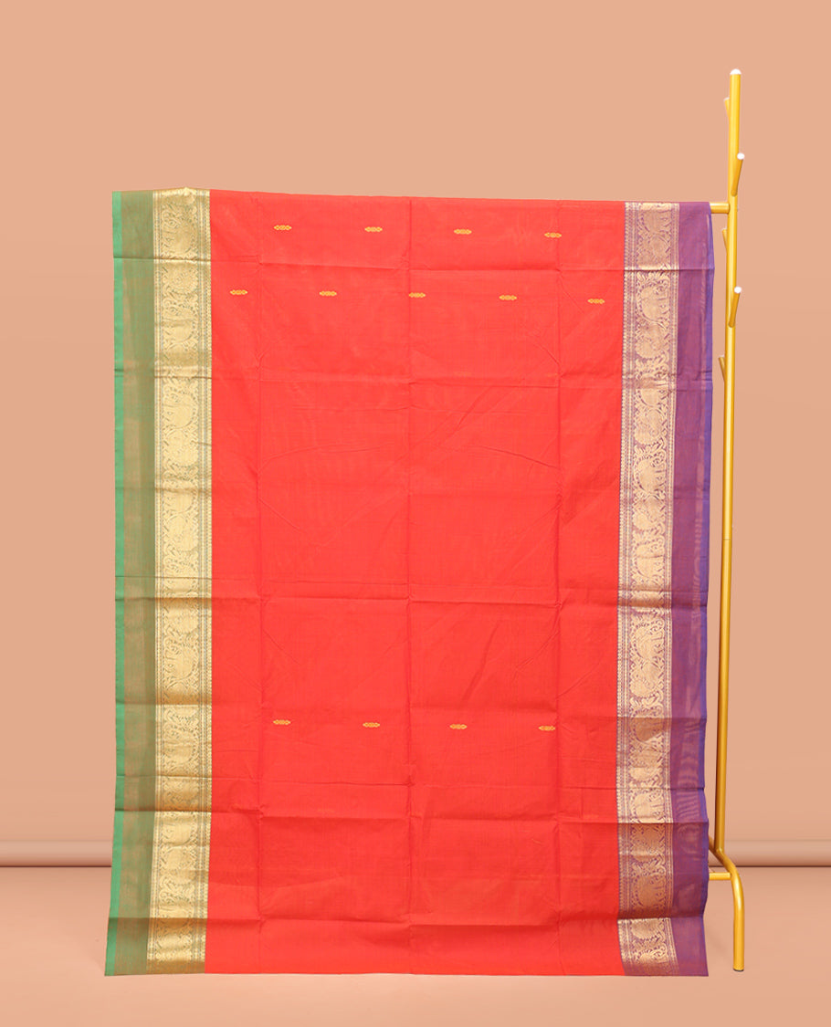 Red Chettinad Cotton Saree, Delicately Woven with Thread Buttas All Over Its Body, Complemented by a Contrast Ganga-Jamuna Kal Eragina Border of Kodi Peacock and Elephant Designs, Pallu of Buttas and Stripes, and Paired with a Matching Blouse