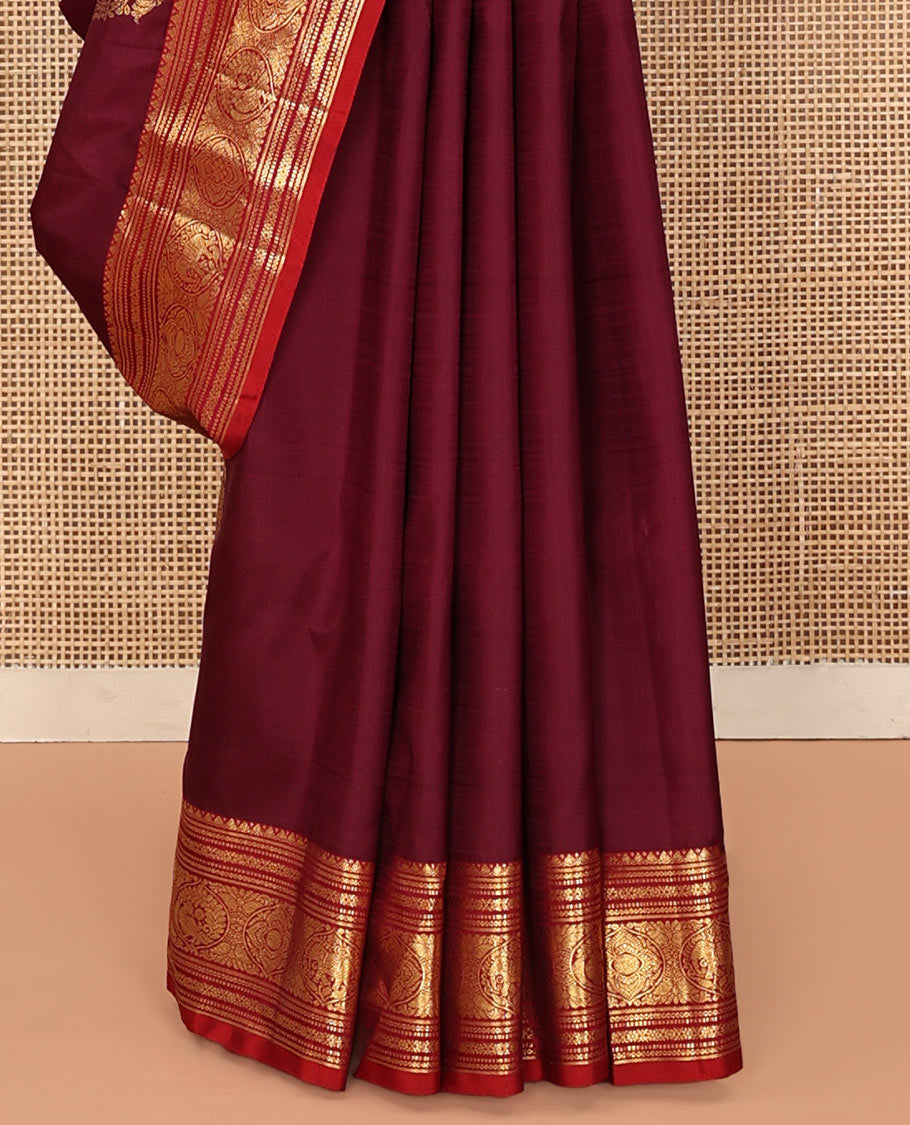 Maroon Kanchipuram Silk Saree, Bedecked with Zari Buttas All Over Its Body, Complemented by a Contrast Border of Neli, Muthu, Cross Kamalam, and Mayil Designs, Pallu of Butta Enclosed Checked Designs, and Paired with a Contrast Blouse