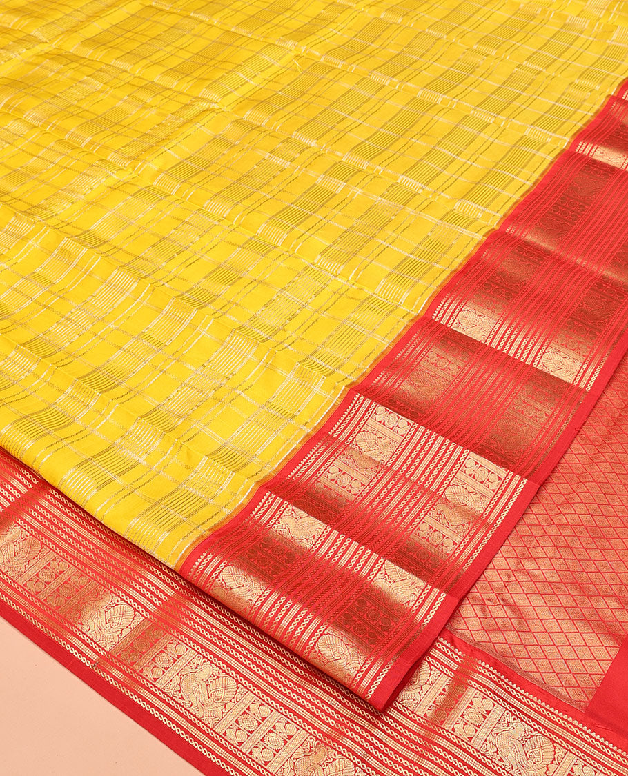 Lemon Yellow and Red Vasundhara Lite Silk Saree, Richly Detailed with Zari Checked Design On Its Body, Complemented by Contrast Varisai Pettu Border of Mayil Chakram Designs, Grand Jaal Pallu, and Paired with a Contrast Blouse