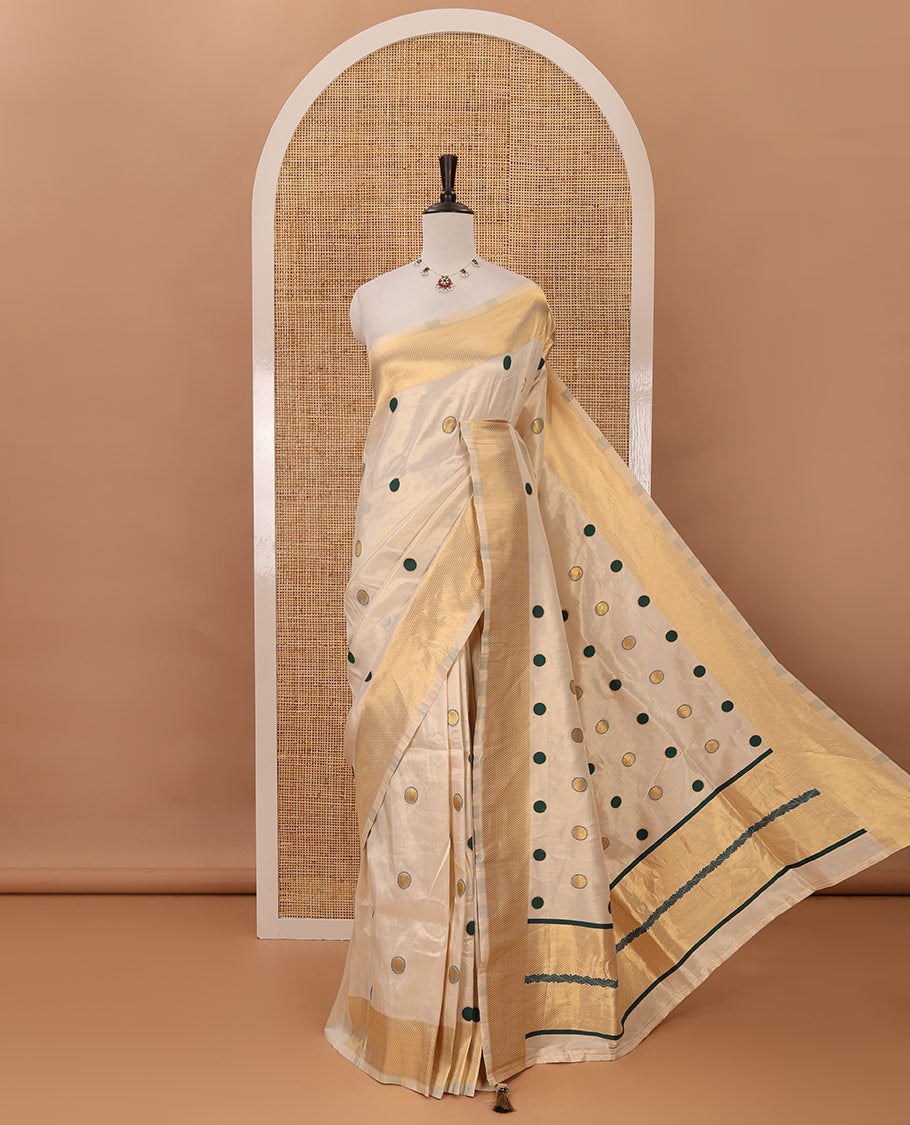 Cream small green polka dots banarasi tissue saree, zari border, pallu of green polka dots & running plain blouse
