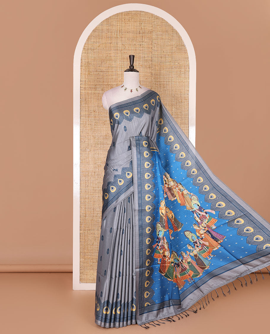 Grey peacock feathers motifs printed katan silk saree, peacock feathers printed border, contrast Radha Krishna stories printed pallu, and contrast printed blouse