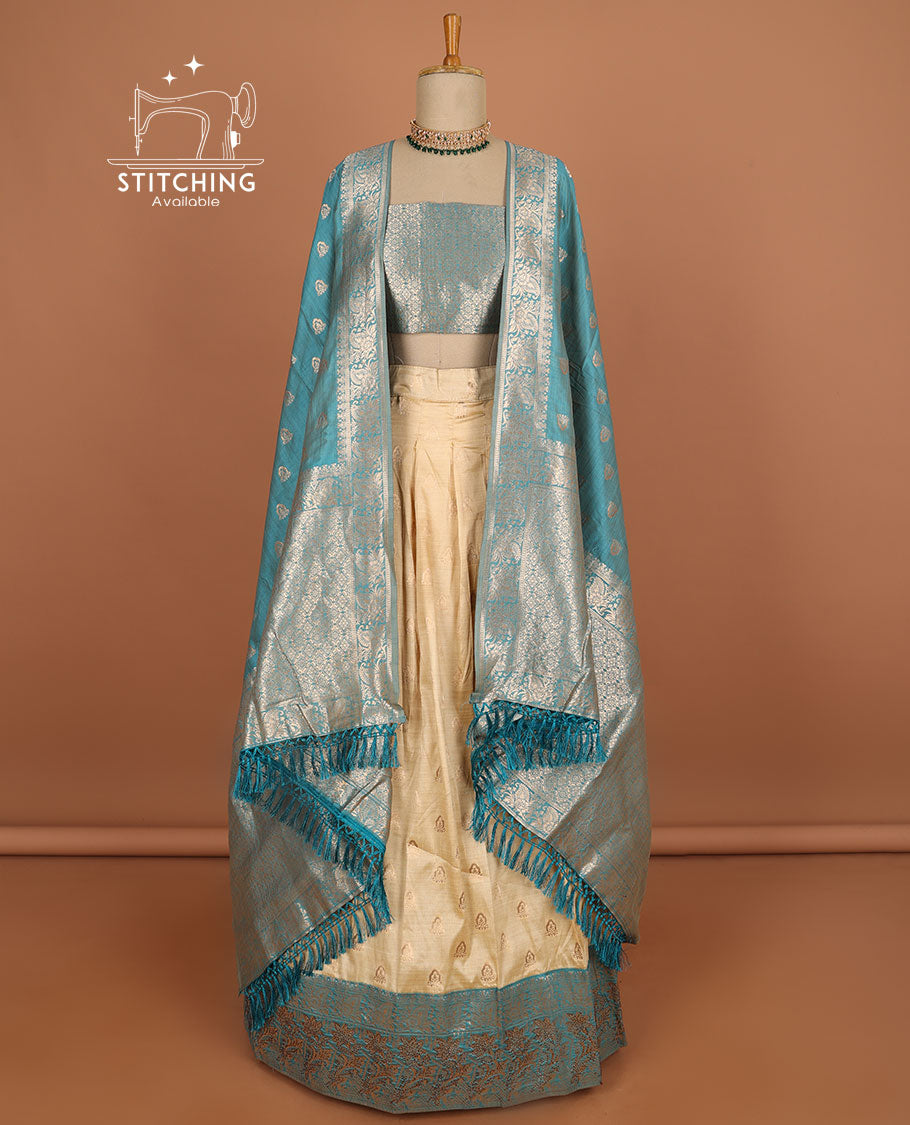 Cream floral buttas half saree with contrast zari border, zari design blouse & blue floral buttas dhavani