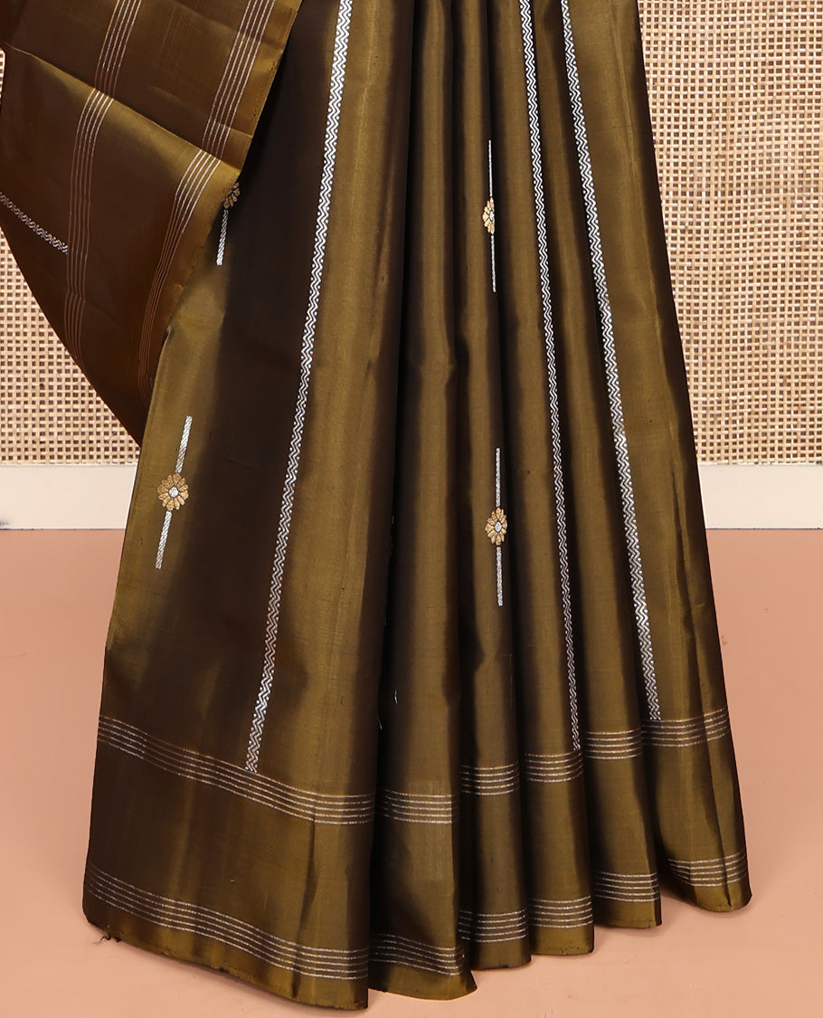 Green Mayuri Soft Silk Saree, Graced with Zari Buttas All Over Its Body, Highlighted by Zari Striped Border, Pallu Steeped with Zari Buttas, and Paired with a Matching Blouse