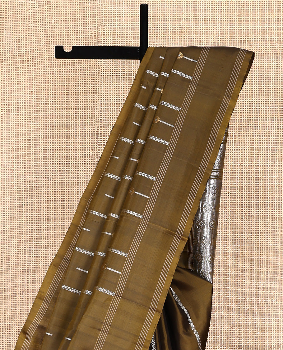 Green Mayuri Soft Silk Saree, Graced with Zari Buttas All Over Its Body, Highlighted by Zari Striped Border, Pallu Steeped with Zari Buttas, and Paired with a Matching Blouse