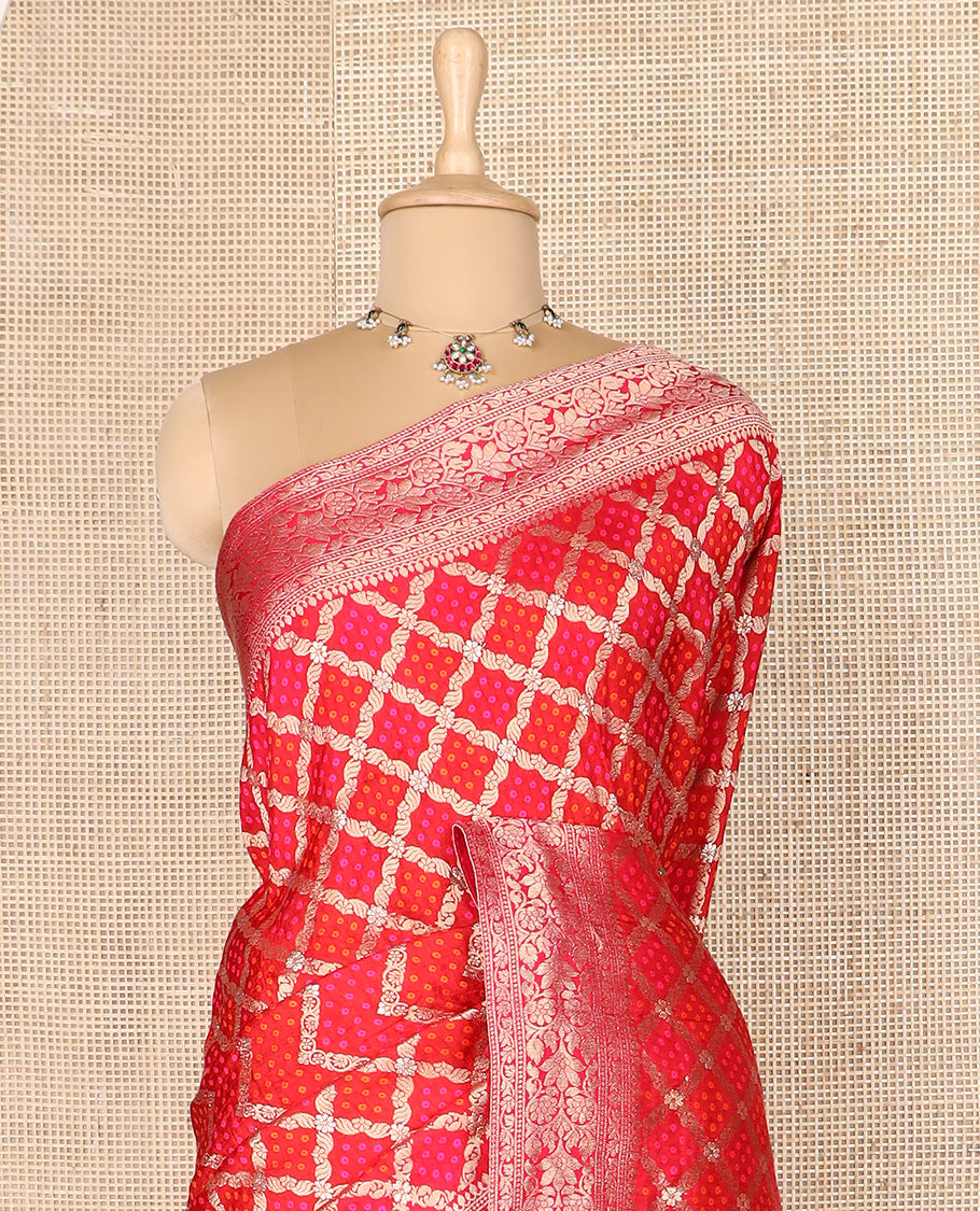 Red bandhani dottes enclosed jaal dola silk saree, traditional zari border, and pallu of intricate designs