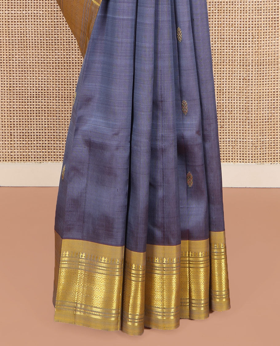 Grey Kanchipuram Silk Saree, Graced with Zari Buttas on Its Body, Complemented by a Contrast One-Sided Border of Panner Sombu, Banaras, Muthu, and Jaal Designs, Pallu of Zari Designs, and Comes Without a Blouse