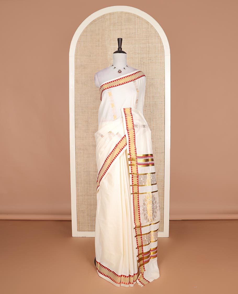 Cream zari design Kerala cotton saree, contrast temple border, and pallu of big chakram motifs