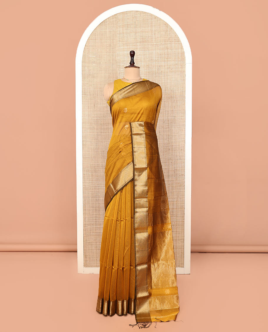 Mustard Maheshwari Cotton Saree, Beautified with Floral Buttas on Its Body, Highlighted by a Zari Border of Traditional Designs, Pallu Steeped with Gleaming Zari Stripes, and Paired with a Matching Blouse