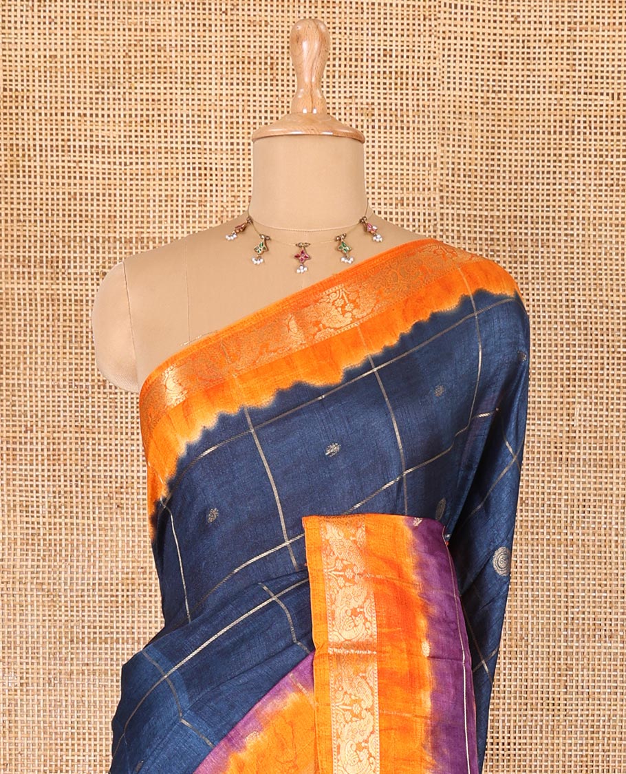 Blue buttas enclosed checked dola silk saree, contrast shibori print with traditional zari border, buttas enclosed checked pallu, and a contrast buttas enclosed checked blouse