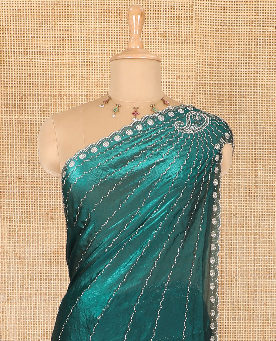 Rama green micro-stone work fendy chiffon saree with paisley stone work on its shoulder, a scallop stone work border, a butterfly style pallu, and a matching stone work blouse
