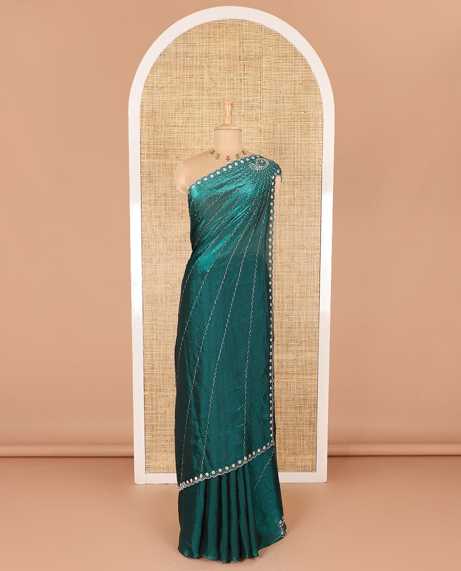 Rama green micro-stone work fendy chiffon saree with paisley stone work on its shoulder, a scallop stone work border, a butterfly style pallu, and a matching stone work blouse