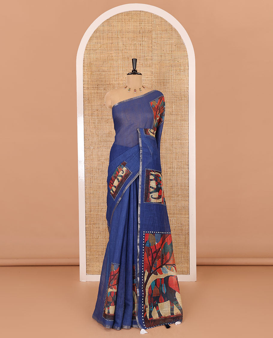 Indigo blue plain linen cotton saree, mordern art style elephant motifs printed border, elephant printed pallu, and a contrast floral vine printed blouse