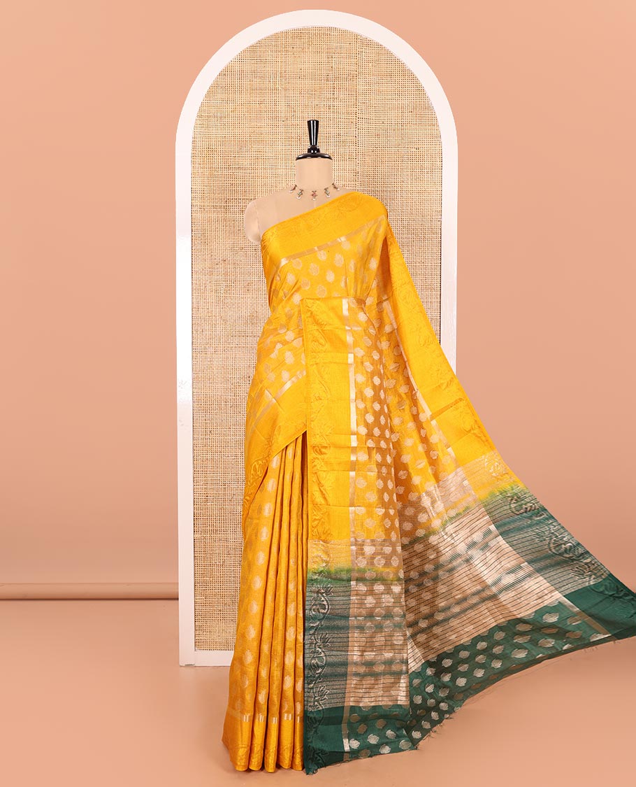Yellow Semi-Tussar Saree Ornamented with Copper Zari Floral Bud Motifs, Featuring a Floral Creeper Embossed Border, Complemented by a Contrast Pallu Adorned with Floral Bud Motifs, and Paired with a Contrast Blouse