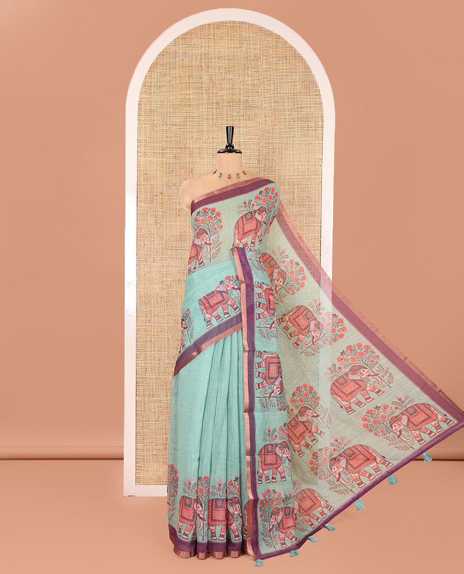 Green Plain Linen Cotton Saree, Artfully Detailed with Elephant Motifs on Piping Border, Pallu of Elephant Motifs Print, and Paired with a Contrast Blouse