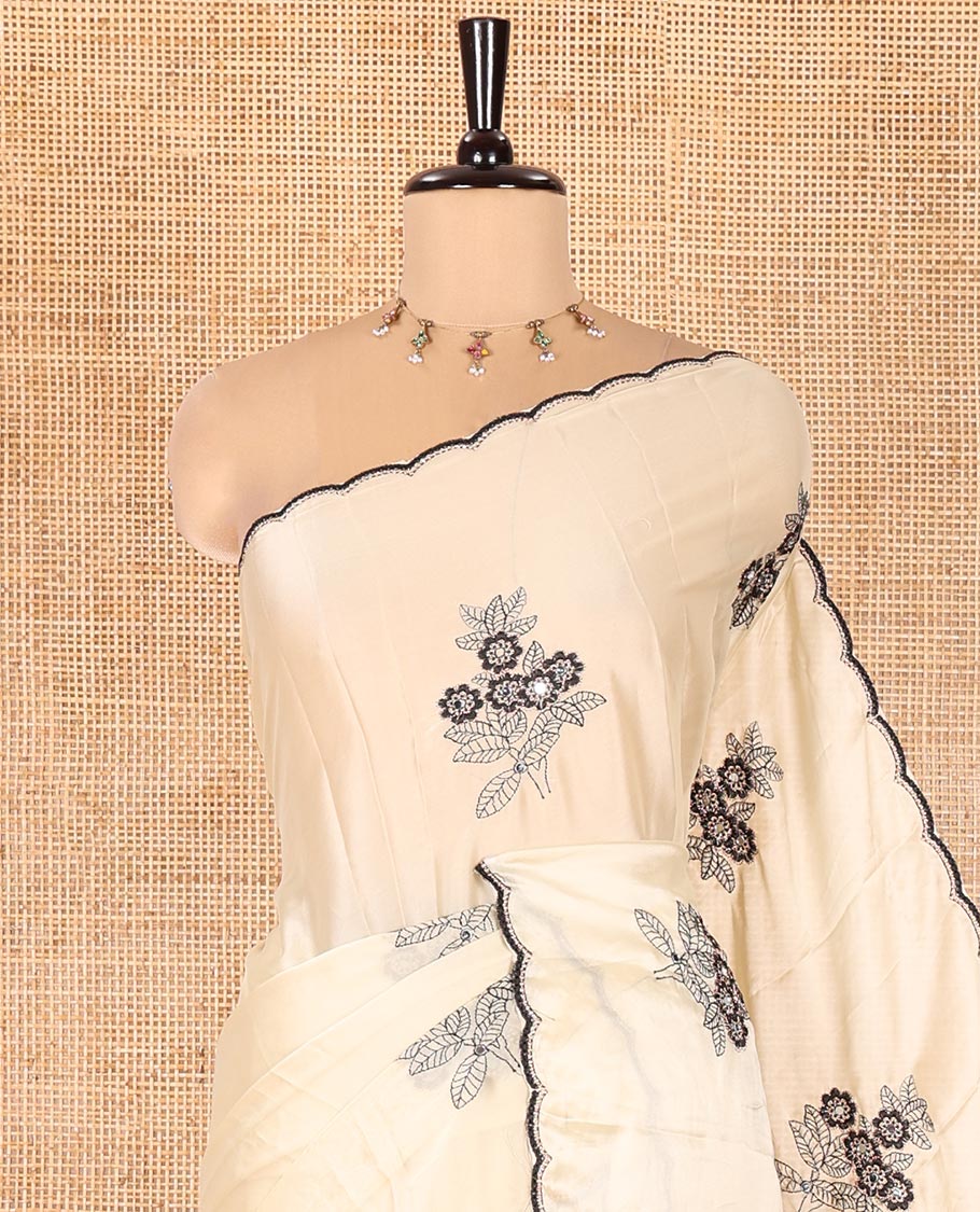 Chikku Rangoli Chiffon Saree, Delicately Woven with Flower-Style Motifs Embroidered on Its Body, a Subtle Scallop Embroidered Border, a Self-Pallu, and Paired with a Contrast Embroidered Blouse