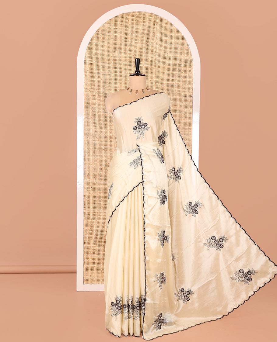Chikku Rangoli Chiffon Saree, Delicately Woven with Flower-Style Motifs Embroidered on Its Body, a Subtle Scallop Embroidered Border, a Self-Pallu, and Paired with a Contrast Embroidered Blouse