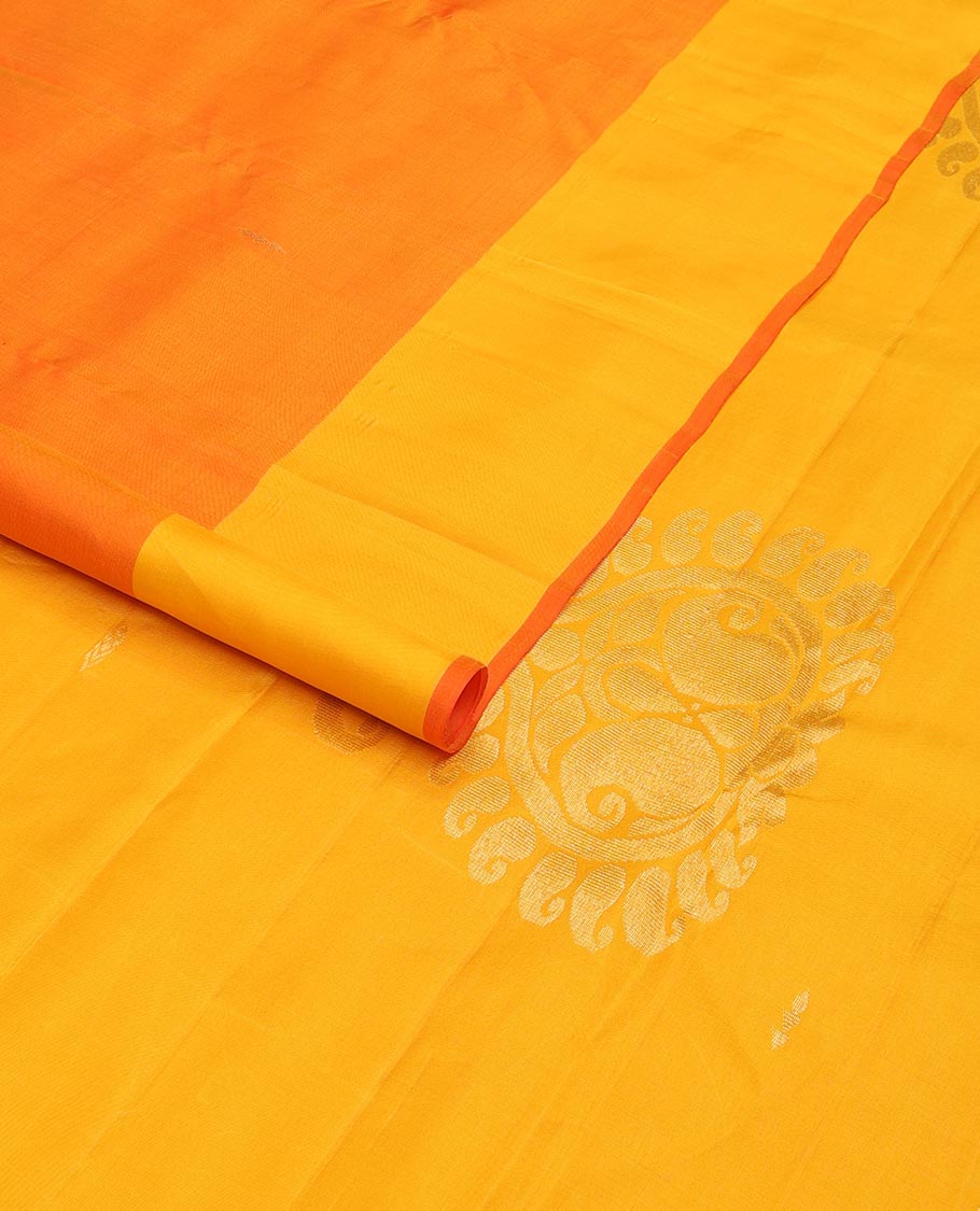 Orange zari buttas Kanchipuram silk saree, contrast floral design border, and pallu of manga designs