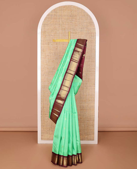 Green floral buttas kancheepuram silk saree with contrast korvai border of thilakam mokku, banaras, geometric design & floral design pallu