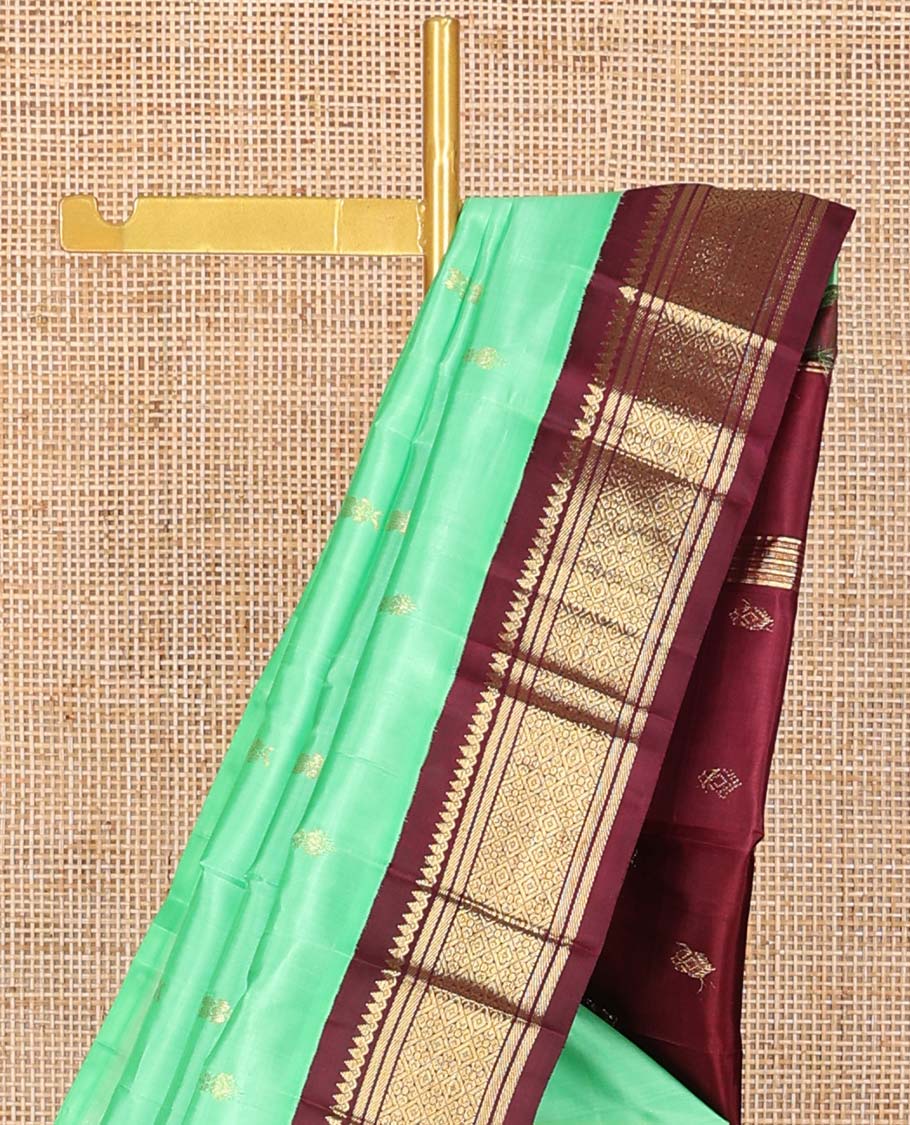 Green floral buttas kancheepuram silk saree with contrast korvai border of thilakam mokku, banaras, geometric design & floral design pallu