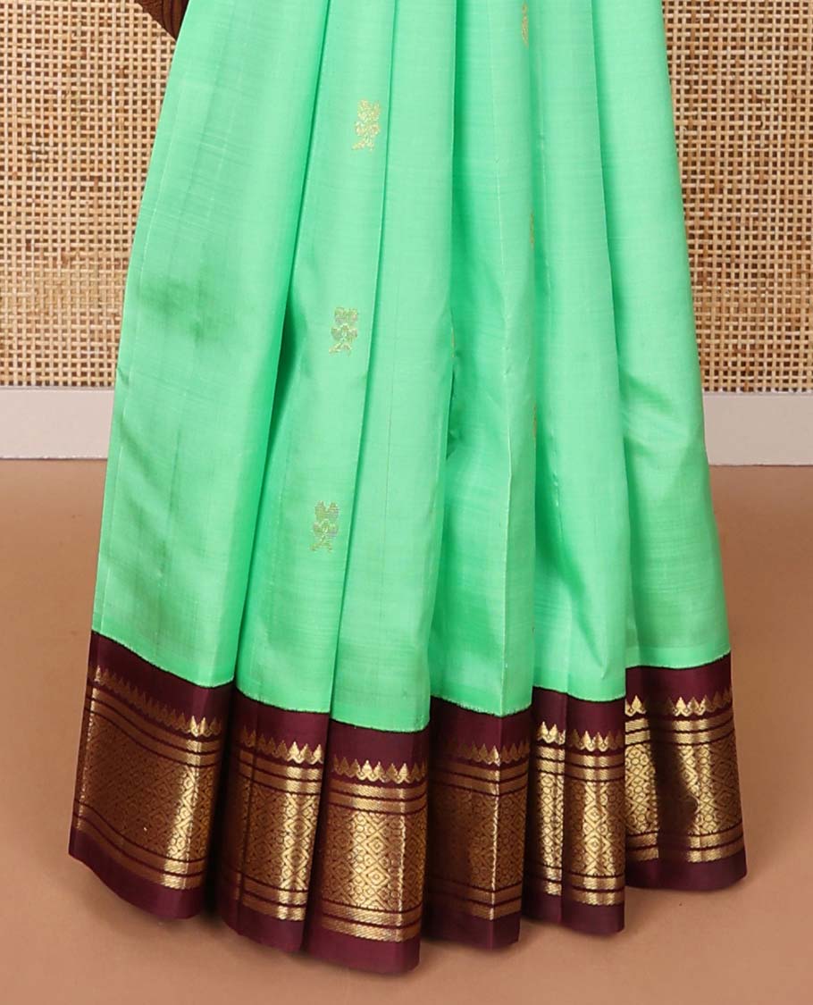 Green floral buttas kancheepuram silk saree with contrast korvai border of thilakam mokku, banaras, geometric design & floral design pallu