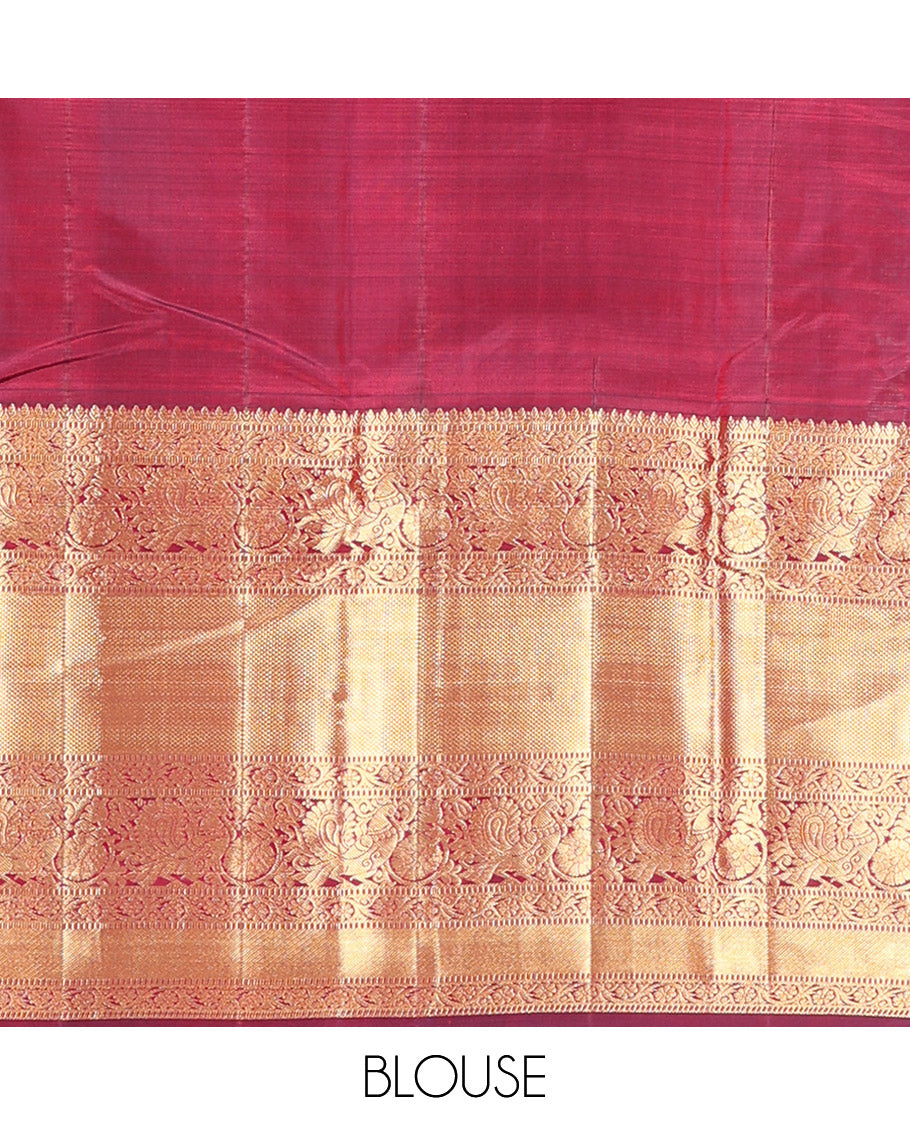 Maroon Vasundhara Silk Saree Ornamented with Zari Buttas All Over Its Body, Highlighted by Zari Border of Rekku, Kodi Visiry, Mayil, and Kuyil Kann Designs, a Grand Pallu of Diagonal Stripes, and Paired with a Matching Blouse