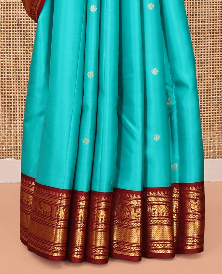 Blue Vasundhara Silk Saree, Mesmerized with Zari Buttas All Over Its Body, Complemented by a Contrast Border of Thilakam, Muthu, Yaanai, Mayil, and Mayil Kann Designs, Grand Jaal Pallu, and Paired with a Contrast Blouse