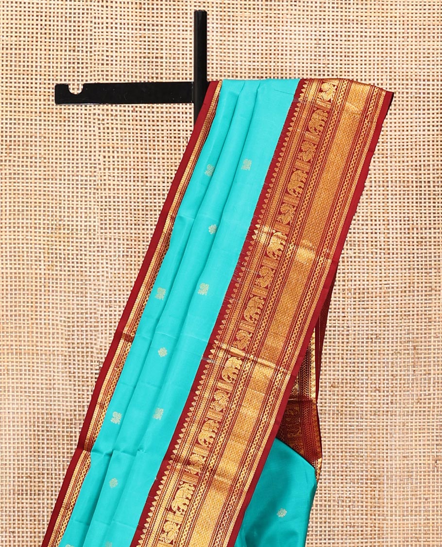 Blue Vasundhara Silk Saree, Mesmerized with Zari Buttas All Over Its Body, Complemented by a Contrast Border of Thilakam, Muthu, Yaanai, Mayil, and Mayil Kann Designs, Grand Jaal Pallu, and Paired with a Contrast Blouse