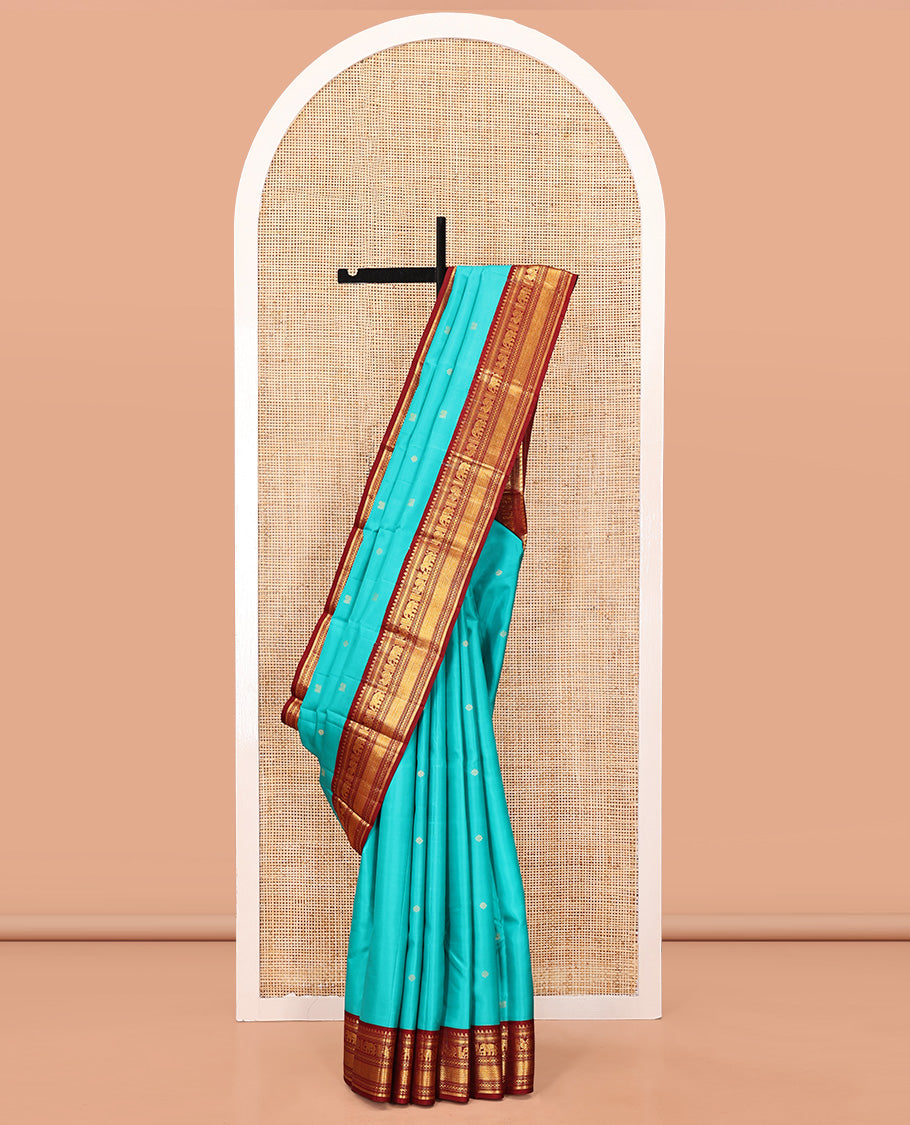 Blue Vasundhara Silk Saree, Mesmerized with Zari Buttas All Over Its Body, Complemented by a Contrast Border of Thilakam, Muthu, Yaanai, Mayil, and Mayil Kann Designs, Grand Jaal Pallu, and Paired with a Contrast Blouse
