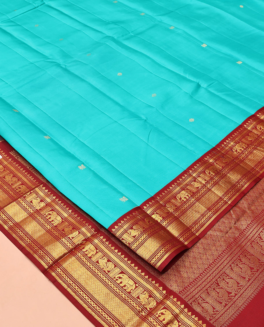 Blue Vasundhara Silk Saree, Mesmerized with Zari Buttas All Over Its Body, Complemented by a Contrast Border of Thilakam, Muthu, Yaanai, Mayil, and Mayil Kann Designs, Grand Jaal Pallu, and Paired with a Contrast Blouse