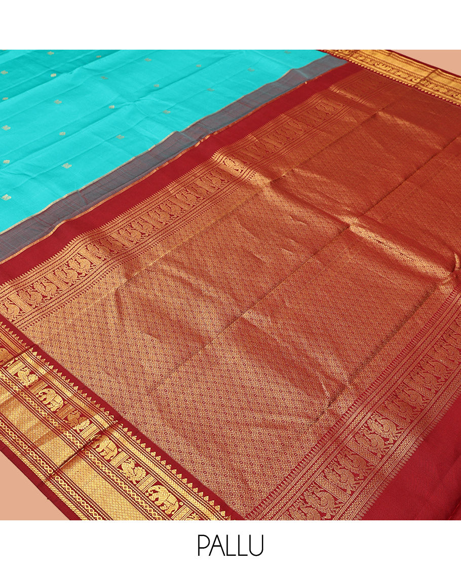 Blue Vasundhara Silk Saree, Mesmerized with Zari Buttas All Over Its Body, Complemented by a Contrast Border of Thilakam, Muthu, Yaanai, Mayil, and Mayil Kann Designs, Grand Jaal Pallu, and Paired with a Contrast Blouse