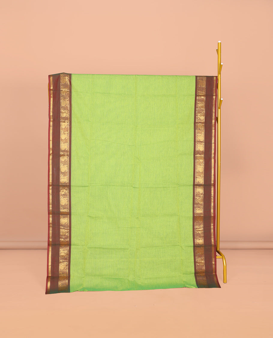 Parrot Green Plain Chettinad Cotton Saree, Complemented by Contrast Traditional Zari Design Rettai Pettu Border of Paisleys, Striped Pallu, and Paired with Matching Blouse