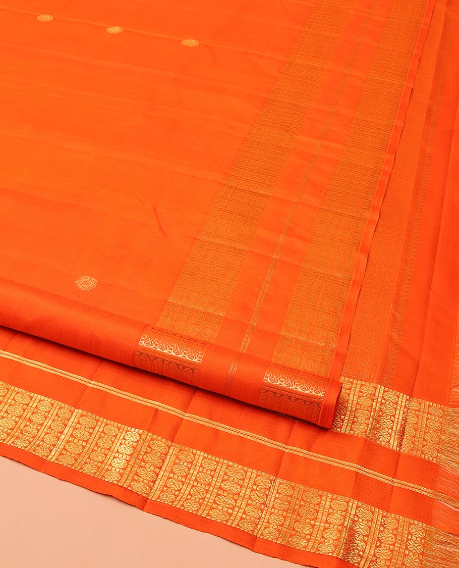 Orange Kanchipuram Silk Saree, Enthralled with Zari Buttas All Over Its Body, Highlighted by a Zari Varisai Border of Rudraksham Enclosed Muthu Kattam Designs, Pallu of Zari Designs, and Paired with a Matching Blouse