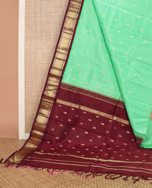Green floral buttas kancheepuram silk saree with contrast korvai border of thilakam mokku, banaras, geometric design & floral design pallu