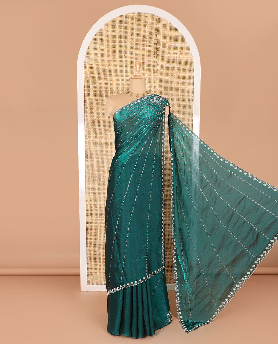 Rama green micro-stone work fendy chiffon saree with paisley stone work on its shoulder, a scallop stone work border, a butterfly style pallu, and a matching stone work blouse