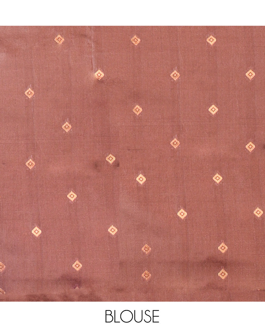 Rust Orange Kanchi Silk Saree Elevated with Floral Butta Enclosed Checks All Over Its Body, Complemented by Contrast Traditional Zari Rettai Pettu Border, Majestically Detailed Pallu, and Paired with a Contrast Blouse