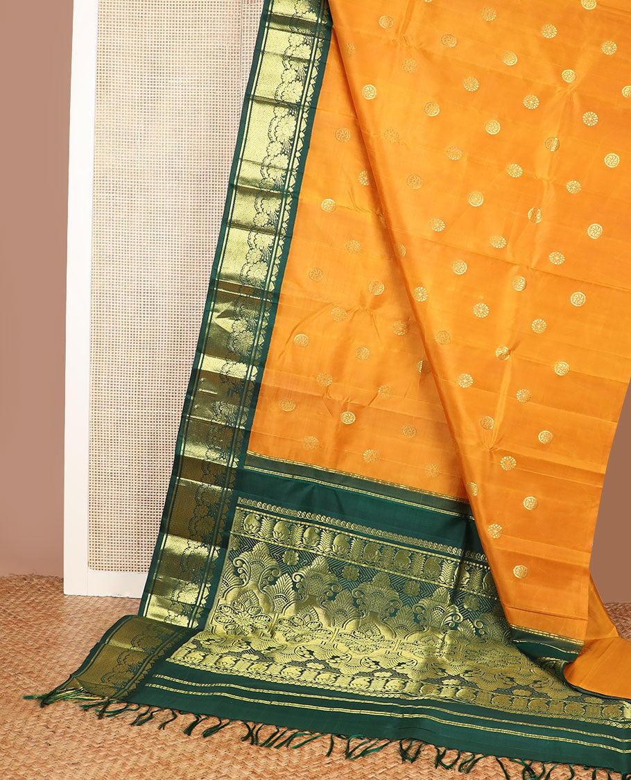 Yellow zari buttas Kanchipuram silk saree, contrast one-sided korvai border of Banaras, floral design & mayil kann & intricate pallu