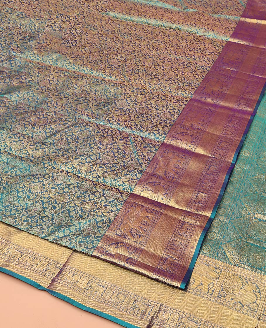 Blue Kanchipuram Wedding Silk Saree, Spotlighted with Jacquard Design Weave, Highlighted by Zari Border of Thilakam Mokku, Muthu, Banaras, Rudraksham, Mayil, Yaanai, and Vanki Designs, Grand Jaal Pallu, and Paired with a Matching Blouse