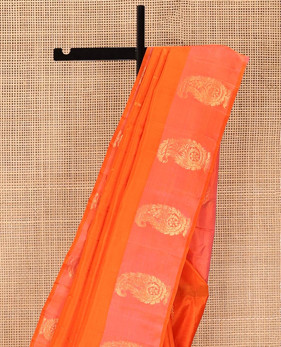 Orange Kanchipuram Silk Saree, Subtly Sparkled with Zari Buttas on Its Body, Complemented by a Contrast Border of Manga Designs, Pallu Steeped with Floral Designs, and Paired with a Contrast Blouse