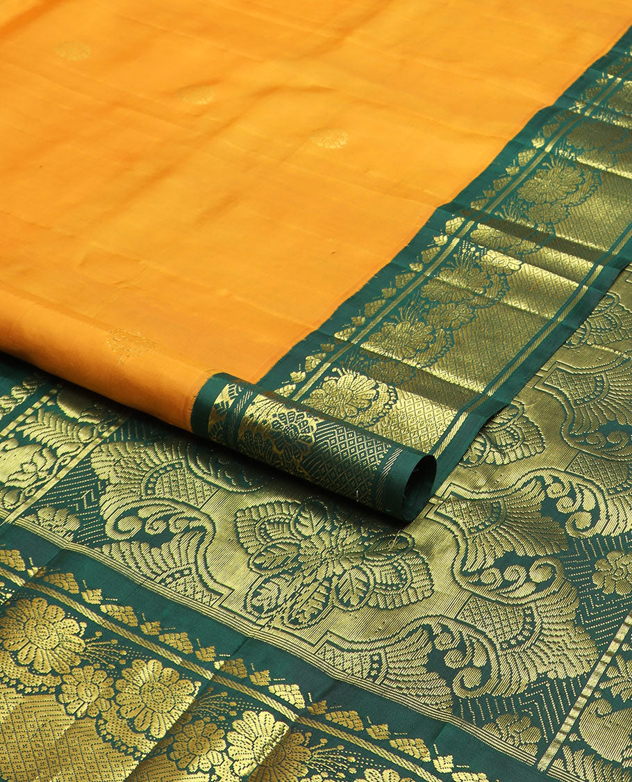 Yellow zari buttas Kanchipuram silk saree, contrast one-sided korvai border of Banaras, floral design & mayil kann & intricate pallu