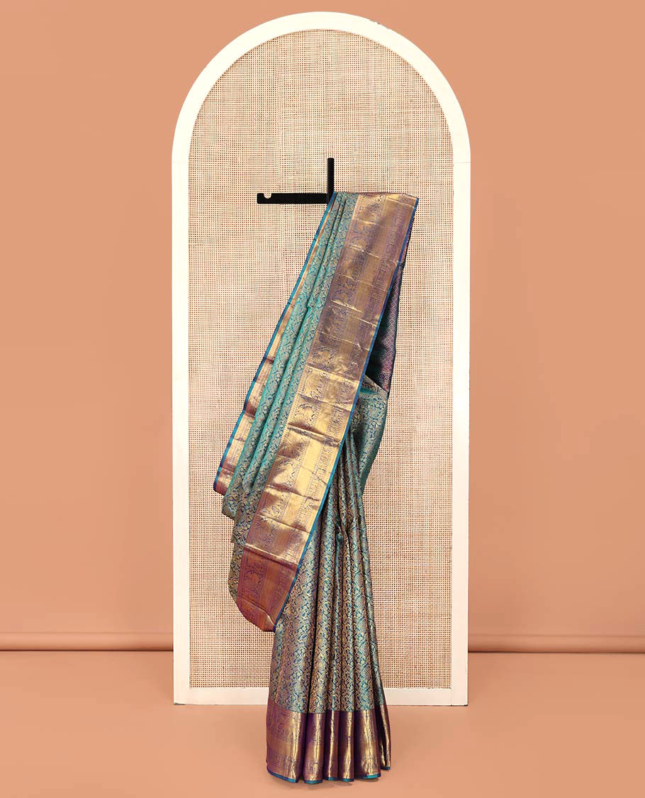 Blue Kanchipuram Wedding Silk Saree, Spotlighted with Jacquard Design Weave, Highlighted by Zari Border of Thilakam Mokku, Muthu, Banaras, Rudraksham, Mayil, Yaanai, and Vanki Designs, Grand Jaal Pallu, and Paired with a Matching Blouse