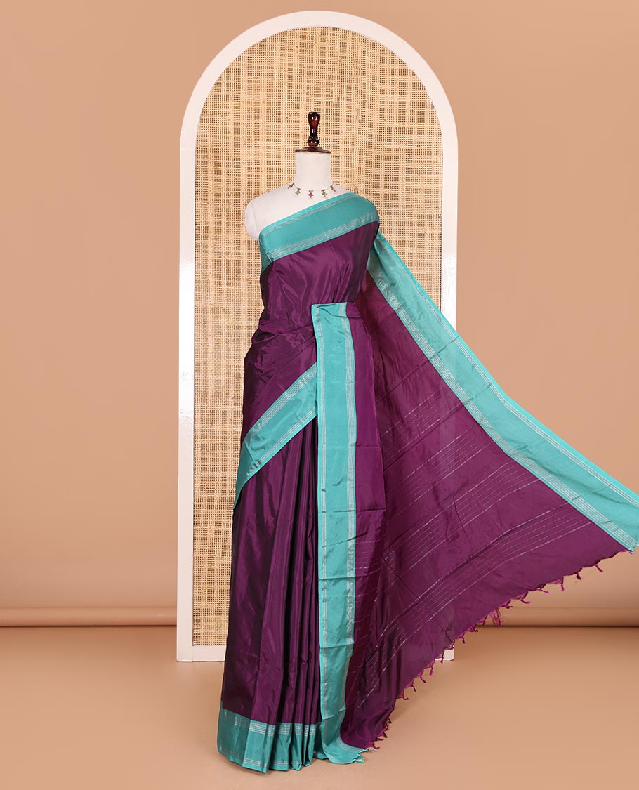 Dark purple plain semi-soft silk saree, contrast zari striped border, striped pallu, and matching blouse