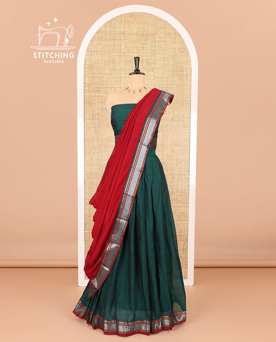 Dark green half-saree, plain with contrast traditional zari bordered skirt, matching blouse, and contrast zari border dhavani
