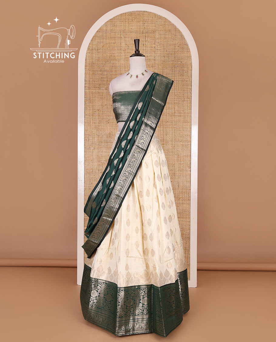 Cream with bottle green semi-banarasi half-saree, zari buttas with contrast traditional zari border skirt, zari jacquard blouse, and zari design dhavani